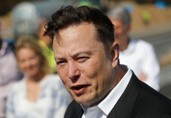 (FILES) In this file photo taken on September 03, 2020 Tesla CEO Elon Musk talks to media as he arrives to visit the construction site of the future US electric car giant Tesla, in Gruenheide near Berlin. - Elon Musk has sold nearly $7 billion worth of Tesla shares, according to legal filings publis