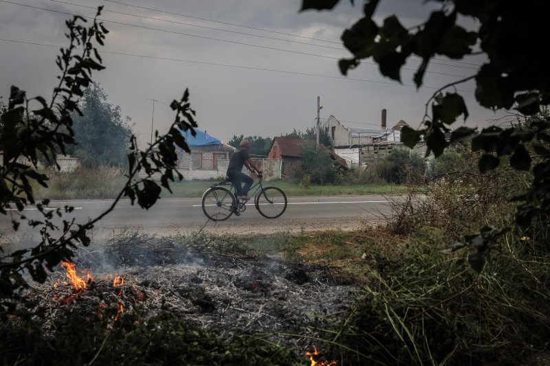 지난해 2월24일(현지시간) 러시아 국경으로부터 17km 떨어진 우크라이나 루스키티슈키 마을에서 한 시민이 자전거를 타고 있다.EPA연합뉴스