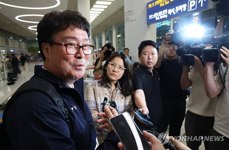 지난달 7일 귀국한 김택규 대한배드민턴협회장이 인천공항에서 기자들의 질문에 답하고 있다. 연합뉴스.