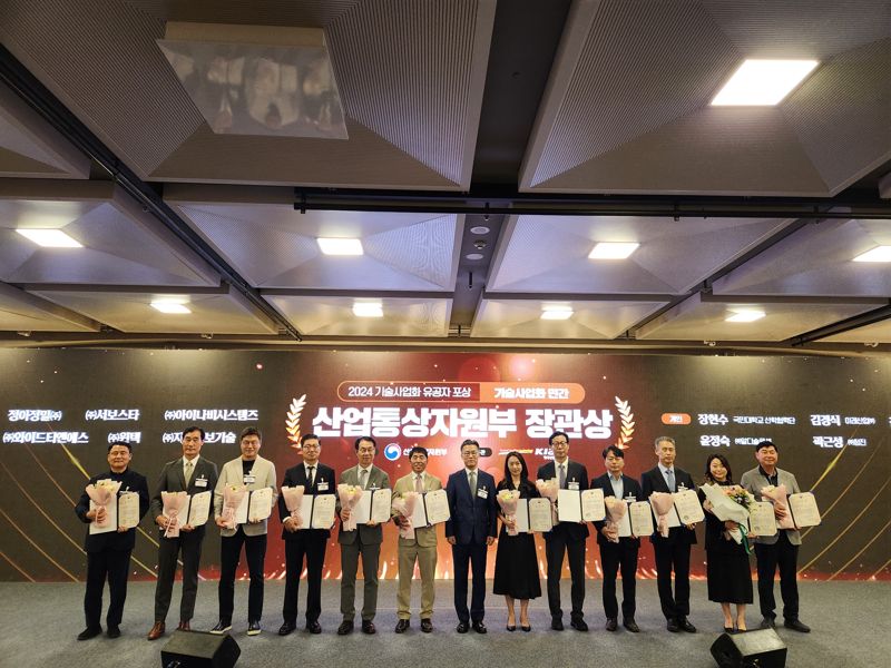 성득영 아이나비시스템즈 대표(왼쪽 셋째)가 2024년 기술사업화 유공 민간 부문 산업통상자원부 장관상 표창을 수상하고 기념촬영을 하고 있다. <span id='_stock_code_084730' data-stockcode='084730'>팅크웨어</span> 제공