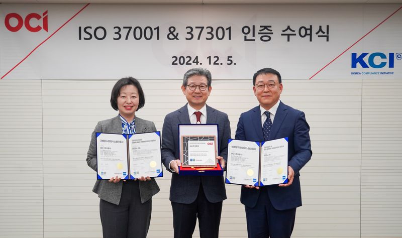지난 5일 <span id='_stock_code_456040' data-stockcode='456040'>OCI</span> 본사에서 진행된 부패방지(ISO 37001) 및 규범준수 경영시스템(ISO 37301) 인증 수여식에서 (왼쪽부터)이수미 OCI 부사장, 김유신 OCI 사장, 이정명 한국준법진흥원 원장이 기념촬영을 하고 있다. OCI제공 
