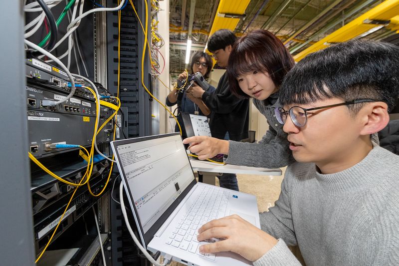 <span id='_stock_code_030200' data-stockcode='030200'>KT</span> 직원들이 5세대(G) 유심망에 양자암호(QKD)와 양자내성암호(PQC)-가상사설망(VPN)을 통합한 하이브리드 양자암호통신 네트워크를 시연하고 있다. KT 제공