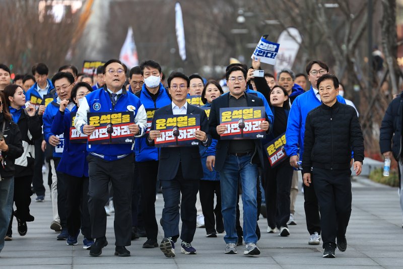 박찬대 더불어민주당 원내대표와 김민석 수석 최고위원을 비롯한 의원들이 13일 오후 서울 종로구 광화문광장에서 윤석열 대통령 파면 촉구 도보행진을 하고 있다. &#x2F;사진&#x3D;뉴스1화상