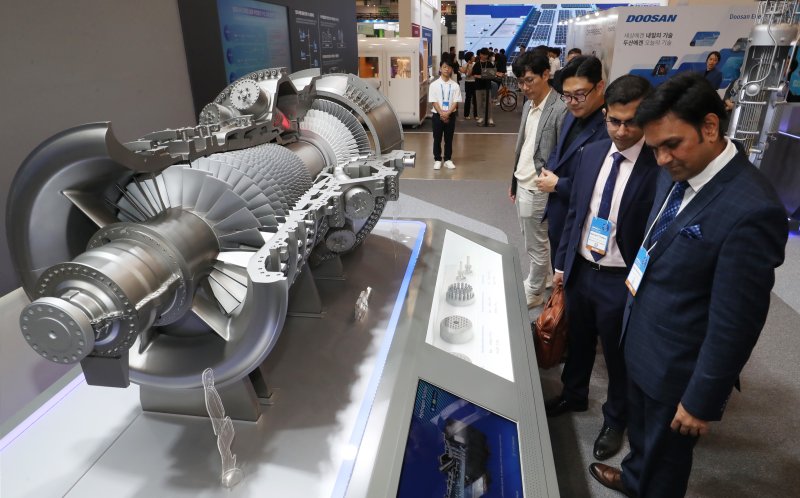 부산 해운대구 벡스코 제1전시장에서 지난해 열린 '2024 기후산업국제박람회'에서 관람객들이 <span id='_stock_code_000150' data-stockcode='000150'>두산</span>에너빌리티 부스를 찾아 수소터빈 모형을 둘러보고 있다. =뉴스1
