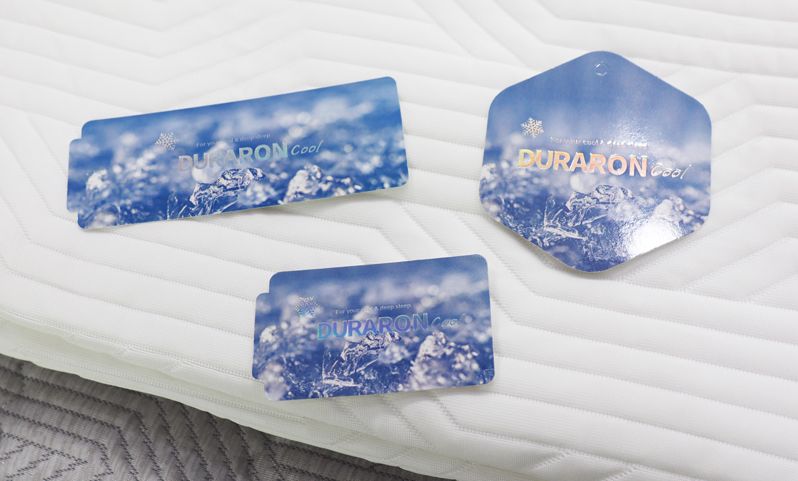 <span id='_stock_code_079980' data-stockcode='079980'>휴비스</span>의 여름철 기능성 섬유인 '듀라론-쿨(Duraron-Cool)'의 2025 시즌 신규 정품 태그(Tag) 3종 이미지. 휴비스 제공