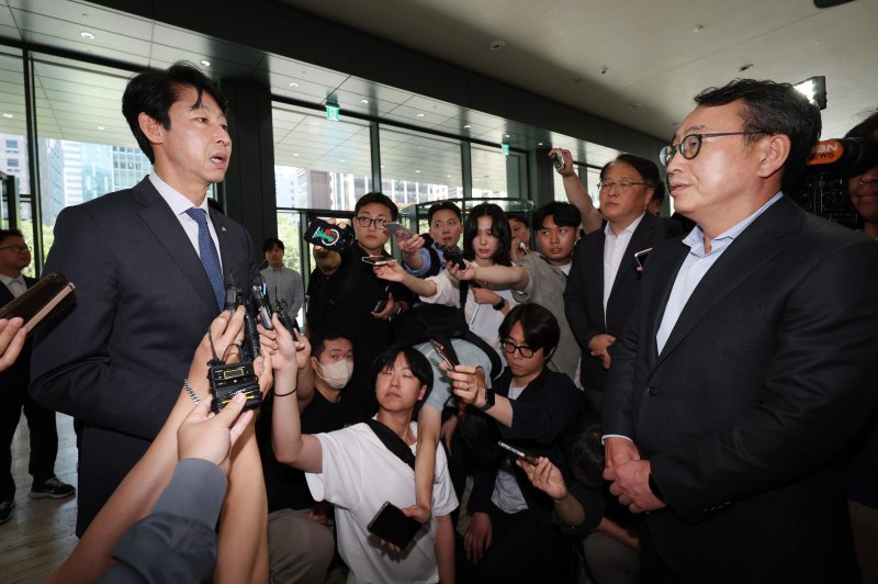 국회 과학기술정보방송통신위원회 소속 이훈기 더불어민주당 의원(왼쪽)이 5일 최태원 SK그룹 회장에게 SK텔레콤 해킹 사태에 따른 위약금 면제를 요청하기 위해 서울 종로구 SK서린빌딩을 방문한 뒤 유영상 SK텔레콤 대표와 대화를 하고 있다. 뉴시스