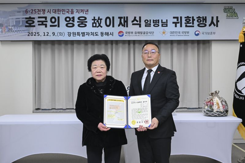 9일 동해시 보훈복지회관에서 고(故) 이재식 일병 귀환행사를 진행했다. 조해학 국유단장 직무대리(오른쪽)가 유가족 대표인 딸 이춘예 씨에게 전사자 신원확인 통지서 전달하고 있다. 국방부 제공