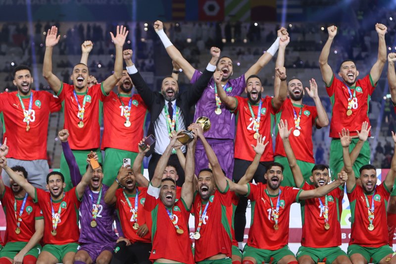 모로코 선수들이 18일(현지 시간) 카타르 루사일 스타디움에서 열린 2025 국제축구연맹(FIFA) 아랍컵 정상에 올라 트로피를 들고 환호하고 있다. 모로코는 결승에서 요르단과 연장 끝 3-2로 역전승을 거두고 우승을 차지했다.뉴시스